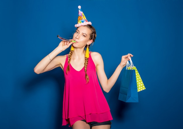 Young beautiful woman holding shopping bags and celebrating