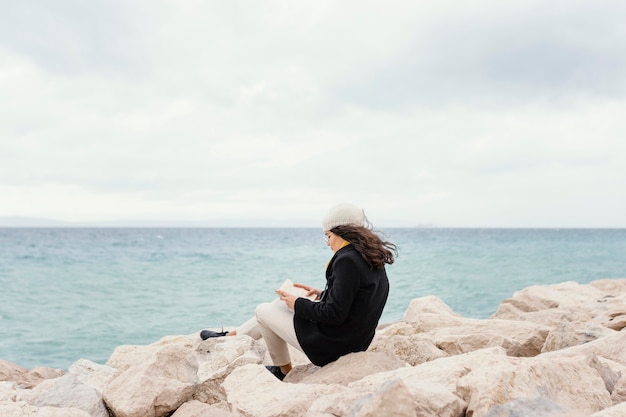 Young beautiful woman in nature reading