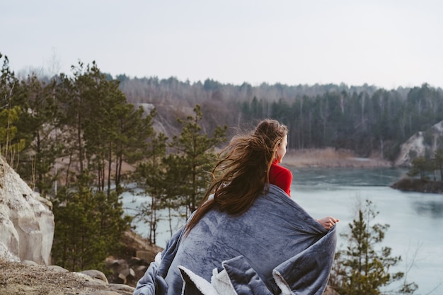 Young beautiful woman posing on a lake