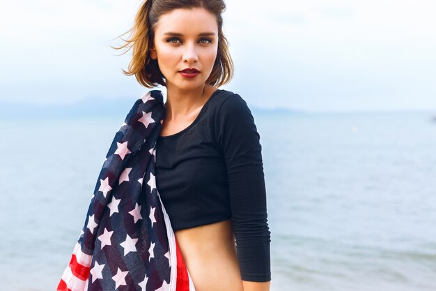 Young beautiful woman posing at sea side