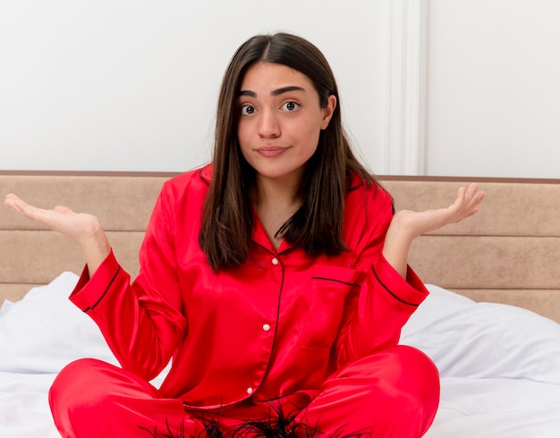 Free Photo young beautiful woman in red pajamas relaxing in bed