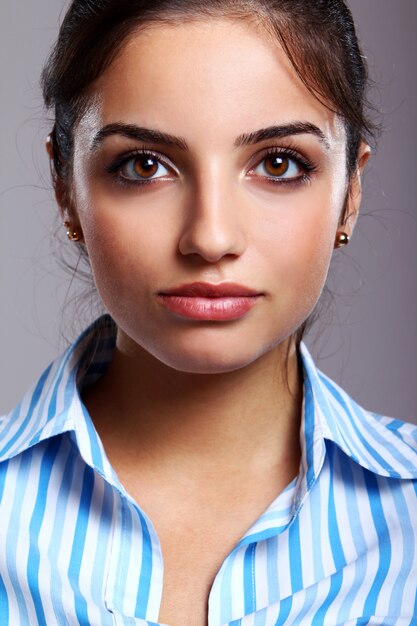 Young and beautiful woman in striped blouse