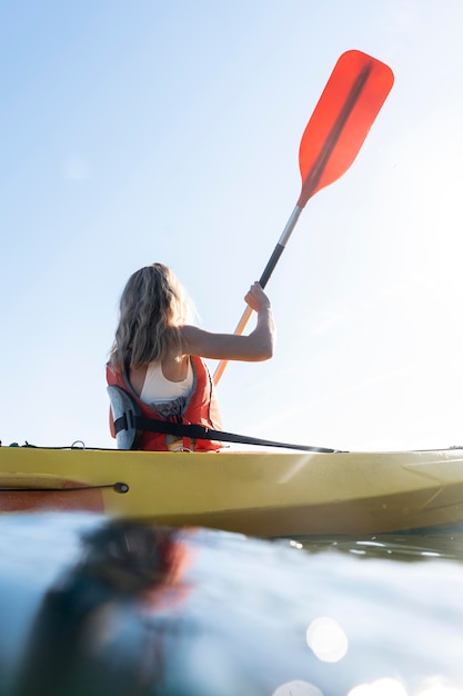 Young beautiful woman traveling by canoe