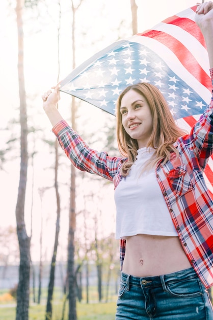 Free photo young beautiful woman waving flag of usa