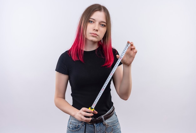 Free photo young beautiful woman wearing black t-shirt holding tape measure on isolated white wall