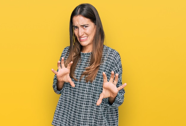 Free photo young beautiful woman wearing casual clothes disgusted expression displeased and fearful doing disgust face because aversion reaction with hands raised