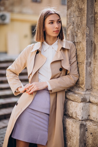 Young beautiful woman wearing coat walking in the city