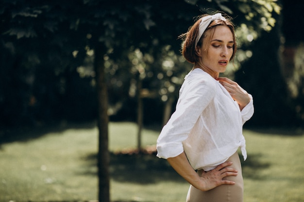 Young beautiful woman in white shirt in the back yard