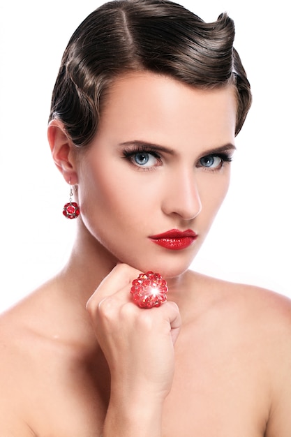 Free Photo young and beautiful woman with red jewelry