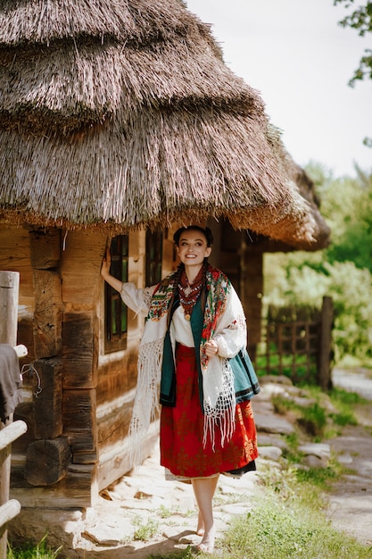 Free Photo young beauty in an embroidered dress smiles while walking