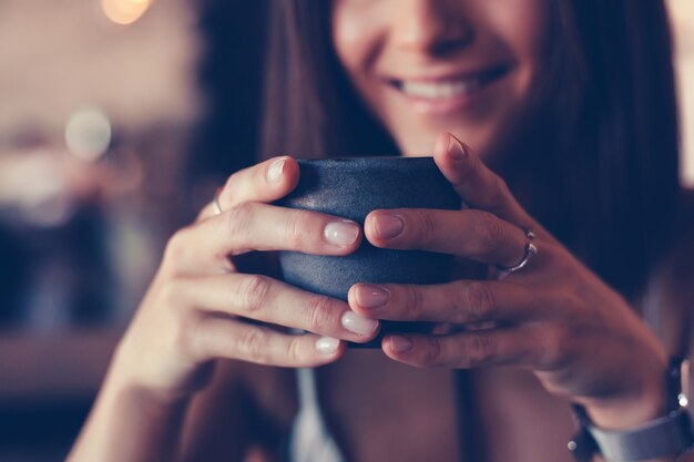 Young beauty woman drinking coffee in cafe, outdoor happy portrait