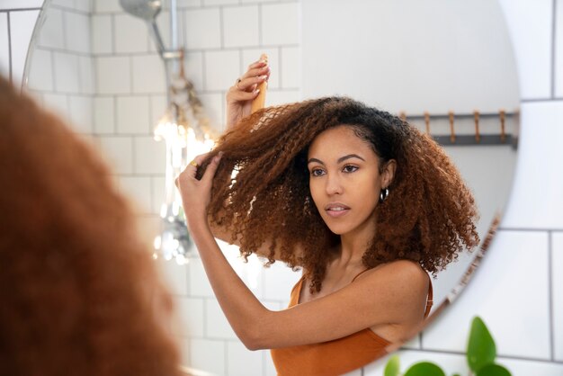 Young black person taking care of afro hair