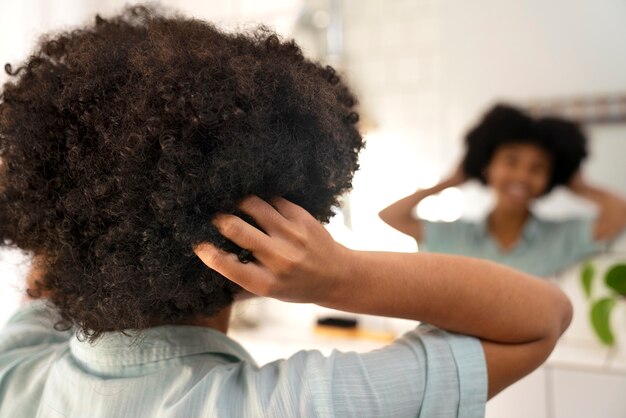 Young black person taking care of afro hair