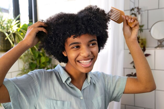 Young black person taking care of afro hair