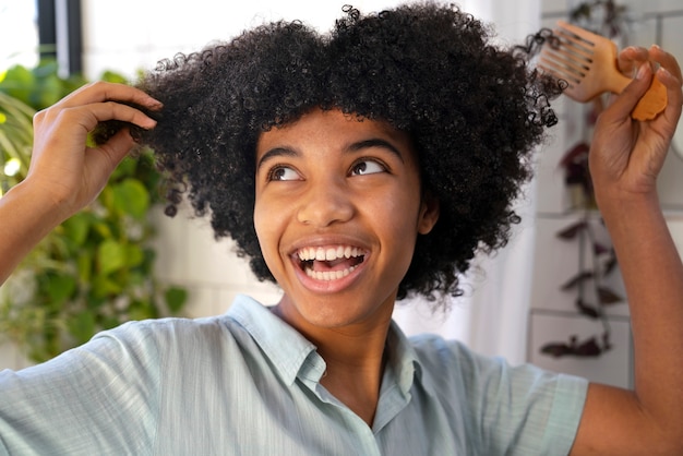 Young black person taking care of afro hair