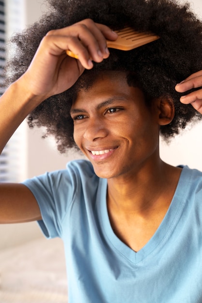 Young black person taking care of afro hair