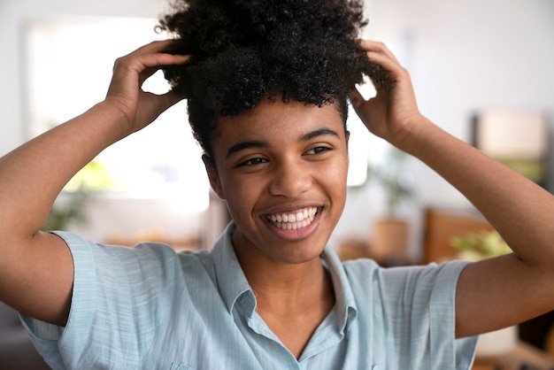 Young black person taking care of afro hair