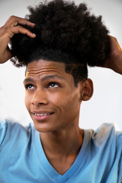 Young black person taking care of afro hair