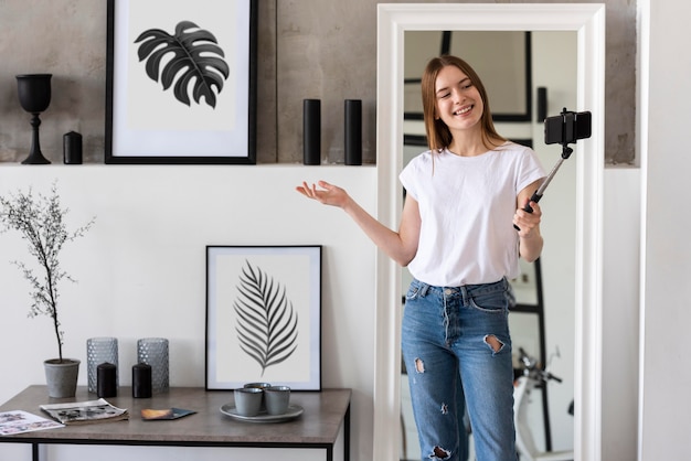 Young blogger recording her house with her smartphone