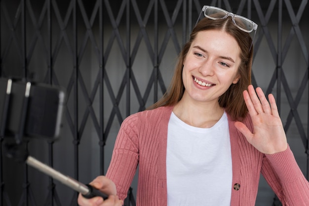 Free Photo young blogger recording herself and waiving