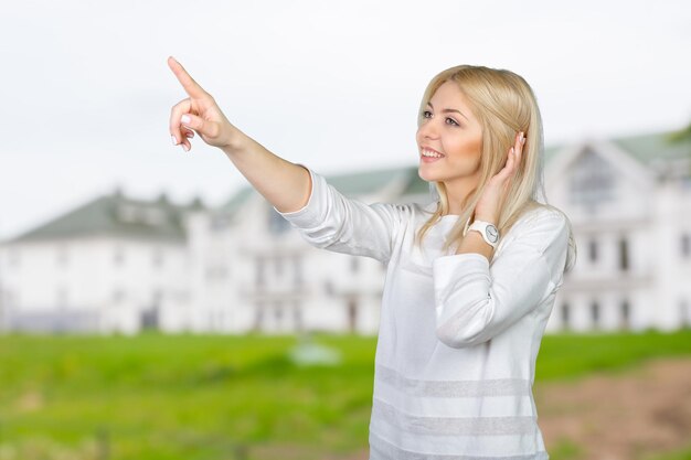 Young blond businesswoman pressing the touchscreen button