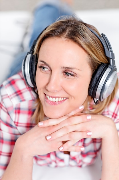 Free Photo young blond woman listening music with headphones