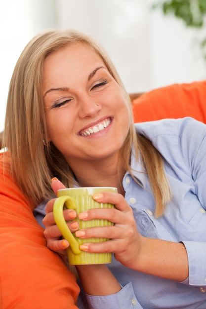 Free Photo young blond woman with mug