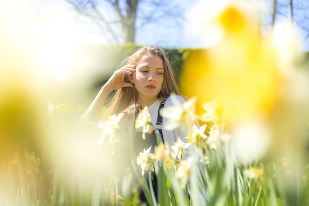 Free photo young blonde caucasian female posing for the camera under the sunlight in the city of pamplona