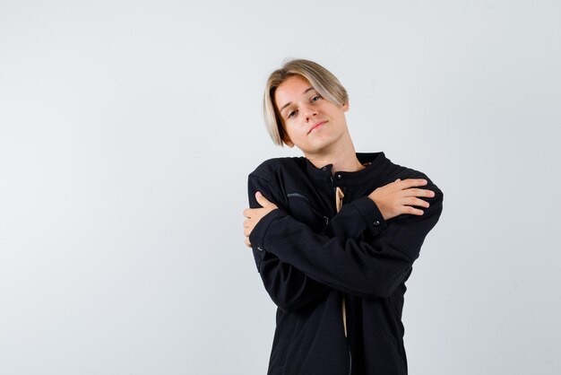 Young blonde girl crossing her arms on white background