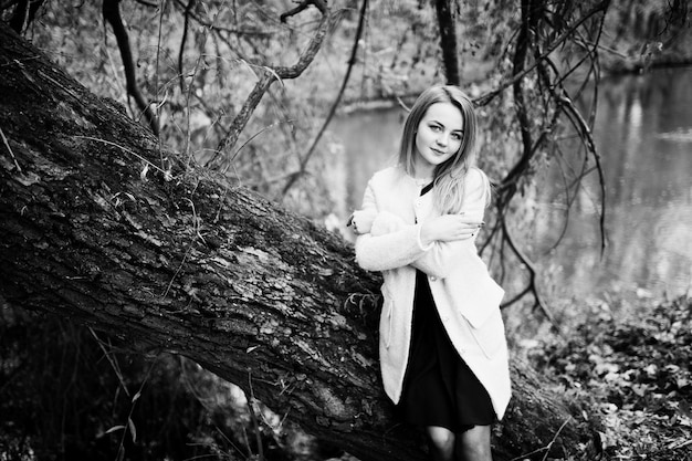 Free Photo young blonde girl at pink coat posed on autumn park