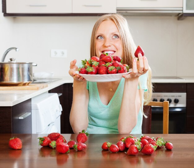 young blonde housewife with  strawberries