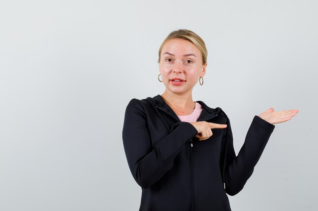 Young blonde woman in a black jacket