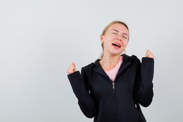 Young blonde woman in a black jacket