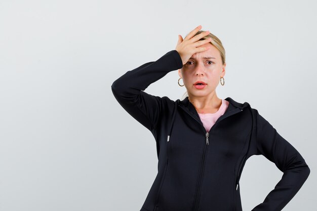 Young blonde woman in a black jacket