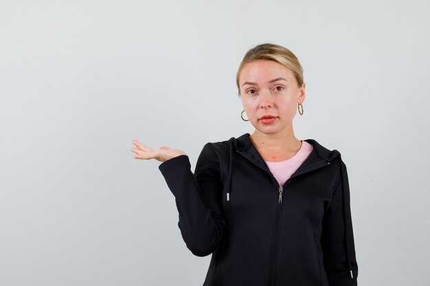 Young blonde woman in a black jacket