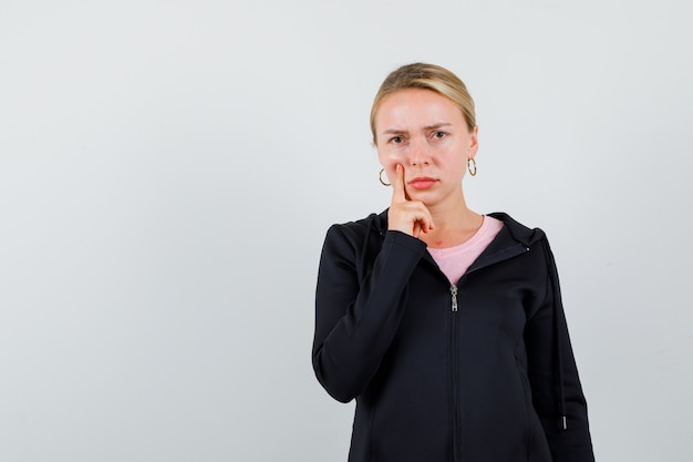 Young blonde woman in a black jacket