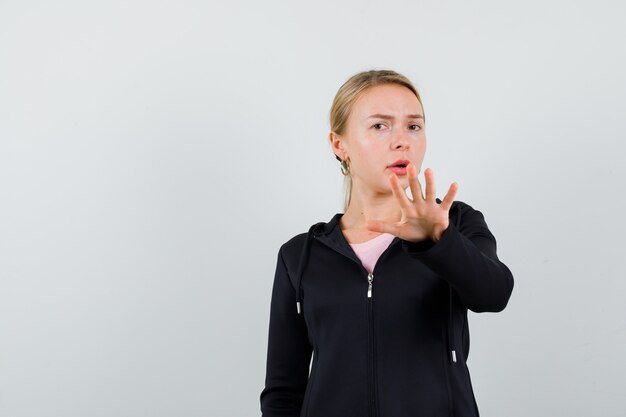 Young blonde woman in a black jacket