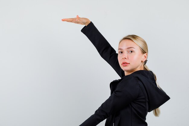 Young blonde woman in a black jacket