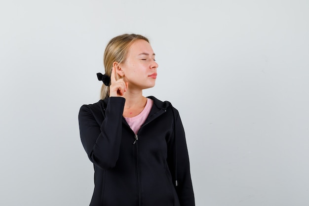 Free photo young blonde woman in a black jacket