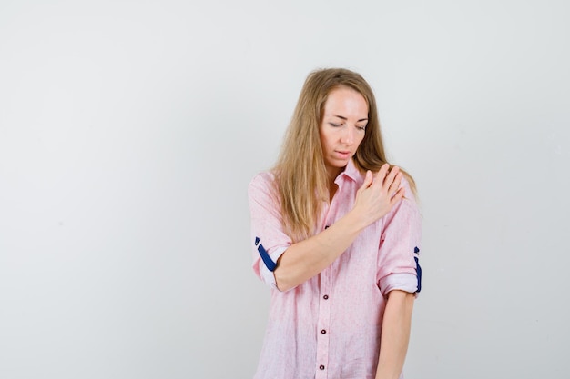 Free Photo young blonde woman in a casual pink shirt