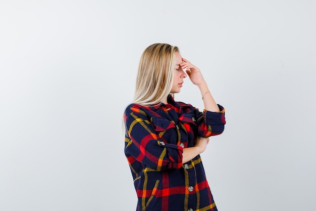 Free photo young blonde woman in a checkered shirt