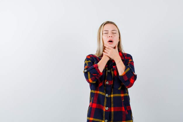 Young blonde woman having a neckache