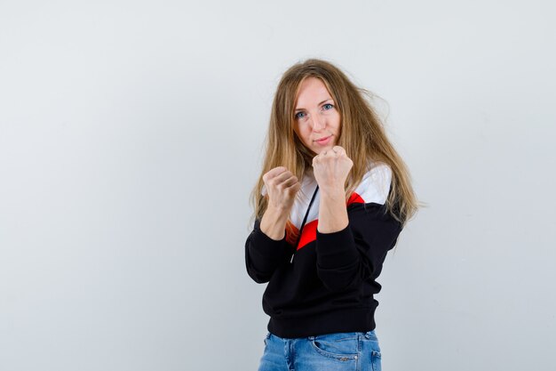 Young blonde woman in a jacket and jeans