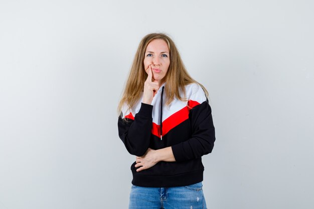 Free photo young blonde woman in a jacket and jeans