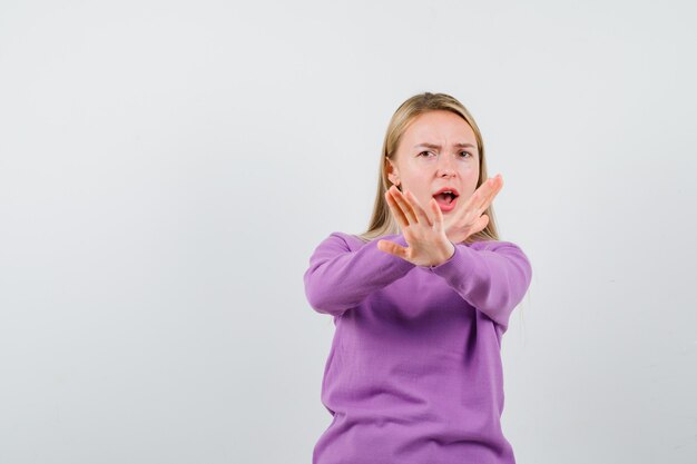 Young blonde woman in a purple sweater