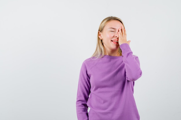 Free Photo young blonde woman in a purple sweater