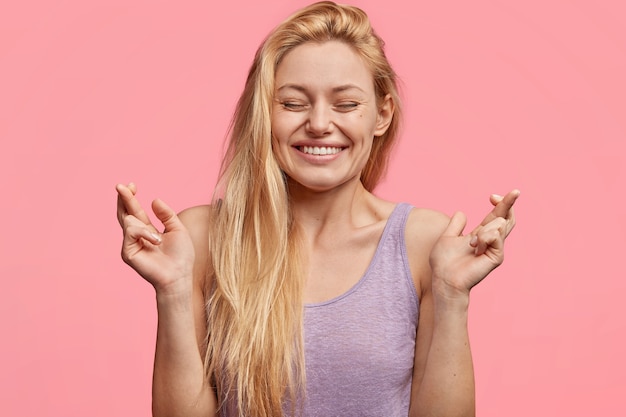 Young blonde woman in purple top