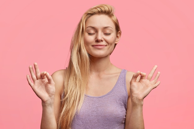 Young blonde woman in purple top