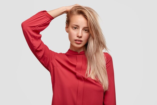 Young blonde woman in red shirt