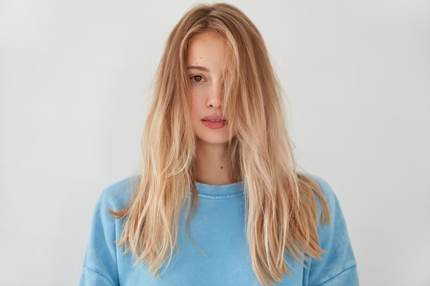 Free Photo young blonde woman wearing blue sweater